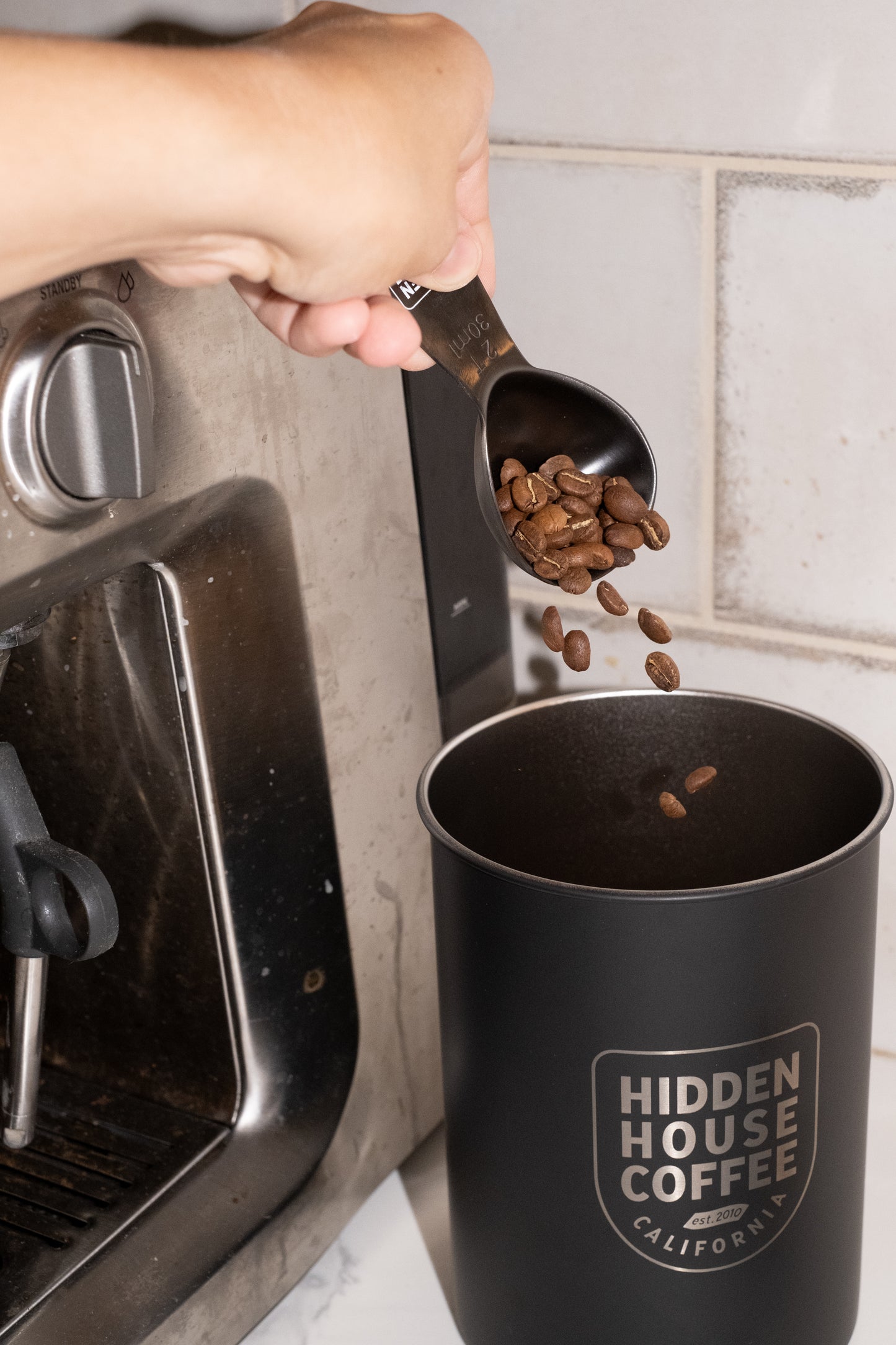 Image of coffee beans being poured into canister.