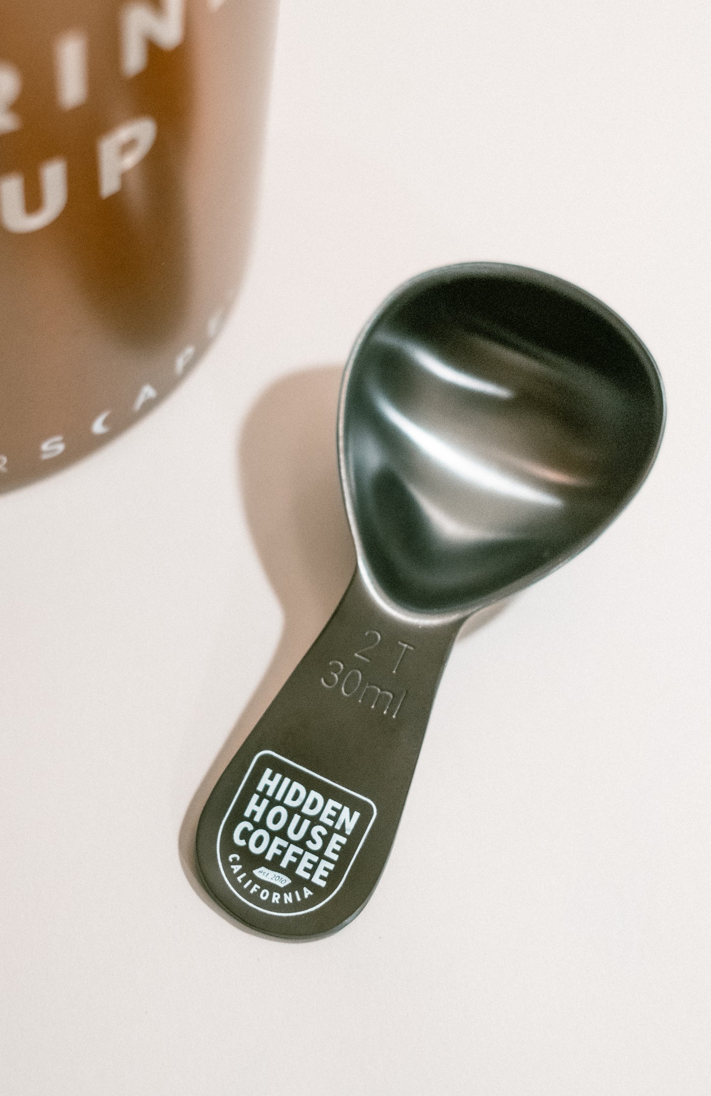 Another picture of metal coffee scoop.
