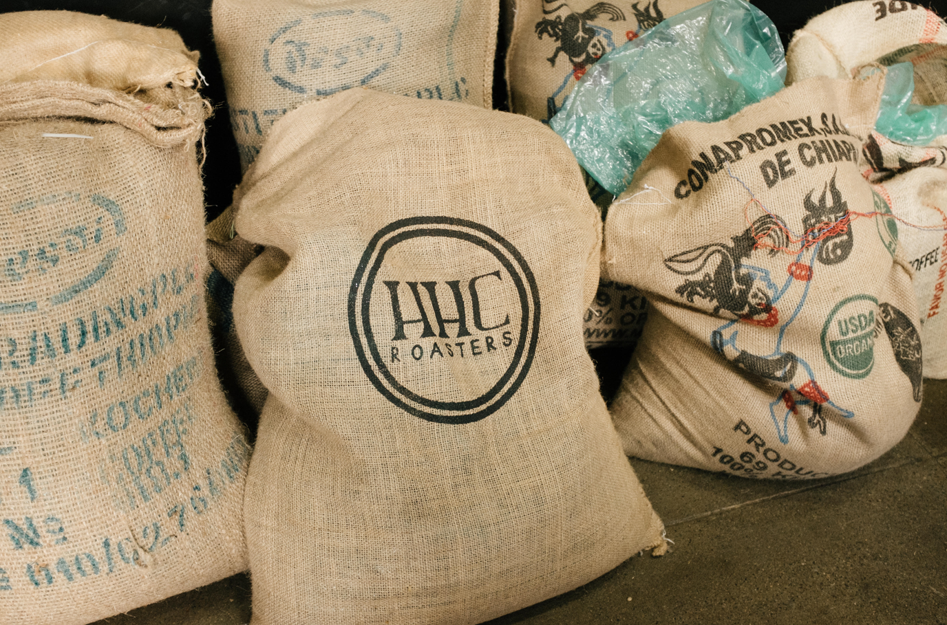 Image of burlap coffee bags with various designs.