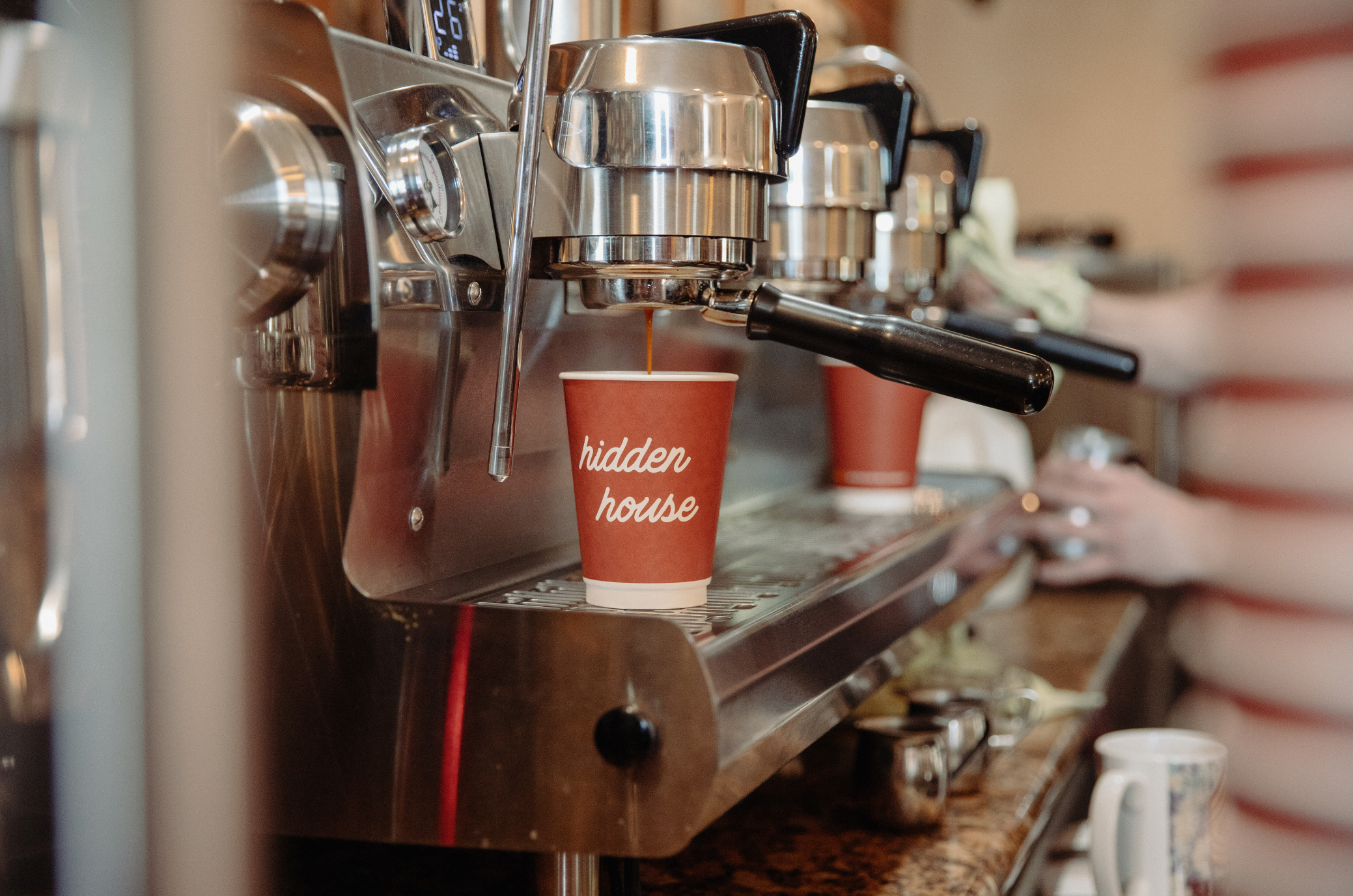 Image of cups on an espresso machine.