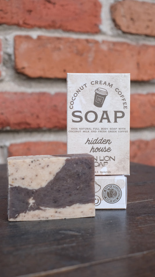 Picture of bar of soap and packaging that it comes in. The package reads "coconut cream coffee soap", "100% Natural full body soap with coconut milk and fresh green coffee."
