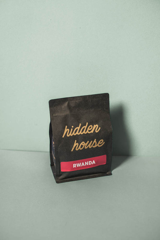 The front of a Rwanda coffee bag with a red colored label