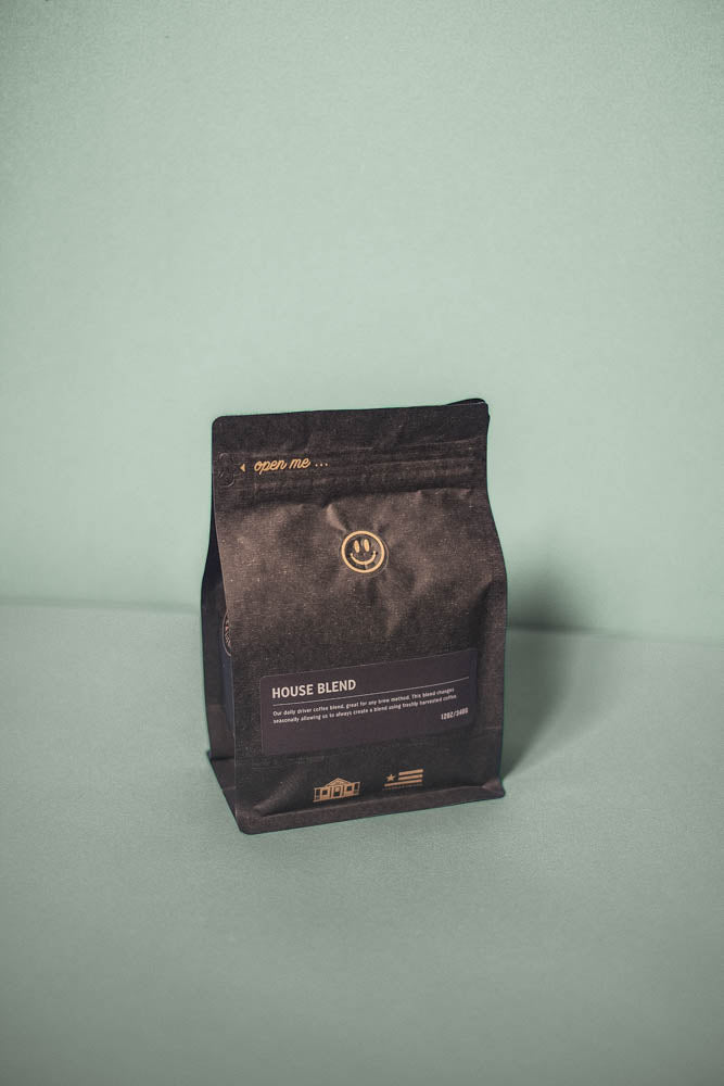 A black coffee bag of House Blend coffee with details