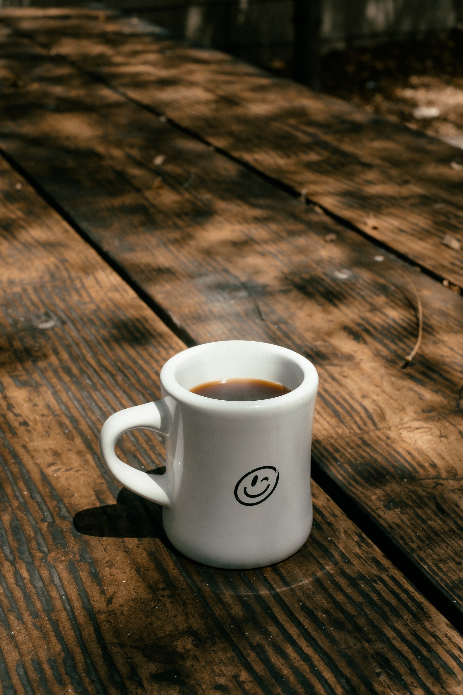 Image of a coffee cup filled with steaming coffee.
