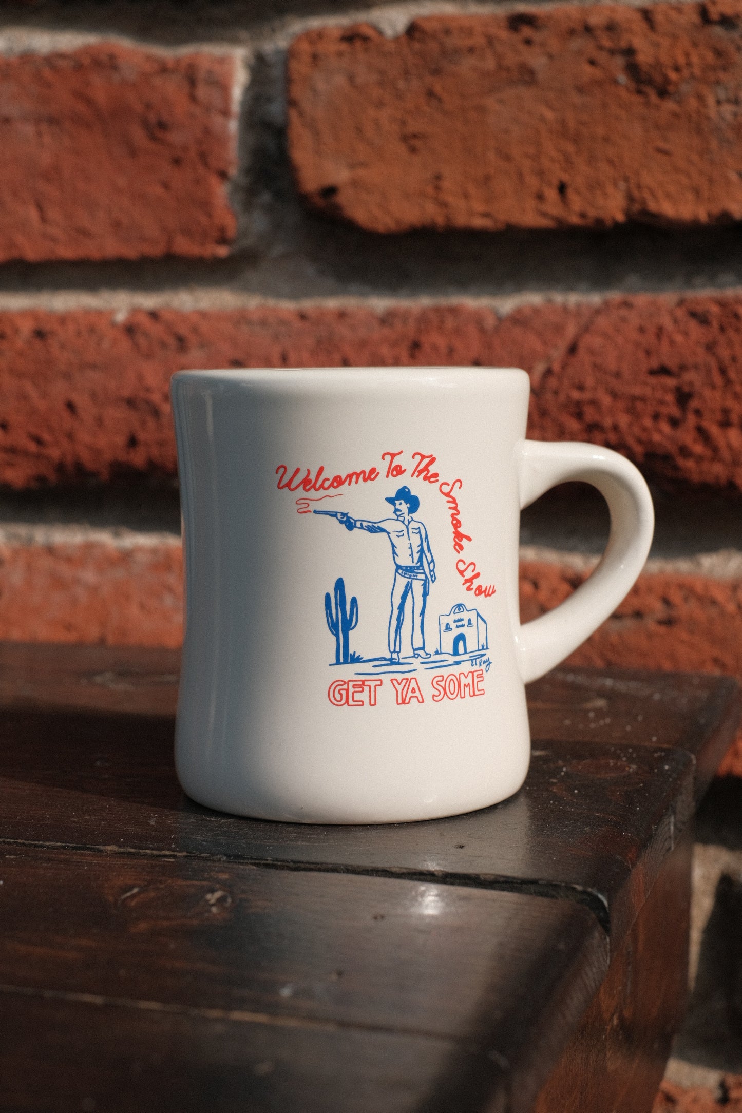 El Ray art pictured on diner mug, with text that says "Welcome to the smoke show, get ya some!"